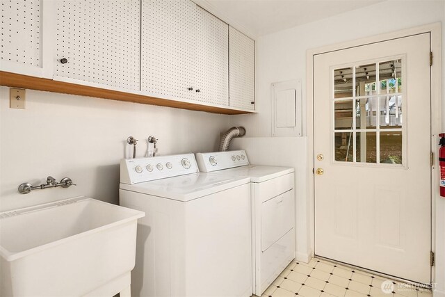 12802 NE 26th Pl, Bellevue, WA 98005 - washroom featuring cabinet space, washing machine and dryer, and light flooring