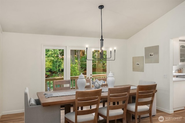 12802 NE 26th Pl, Bellevue, WA 98005 - dining room featuring a chandelier, light wood finished floors, baseboards, and lofted ceiling