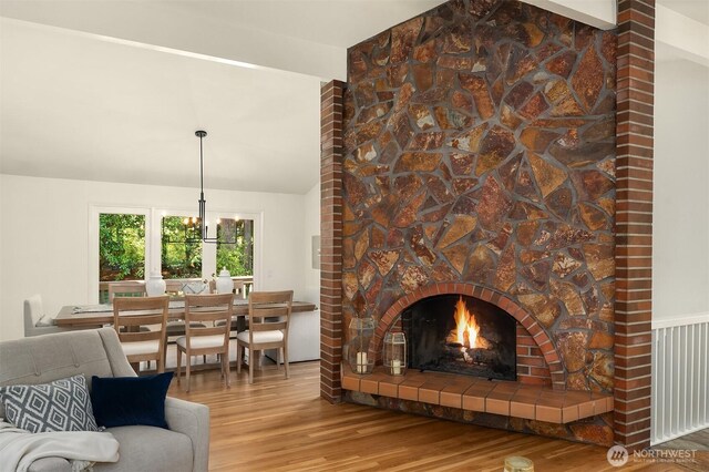 12802 NE 26th Pl, Bellevue, WA 98005 - living area featuring wood finished floors, lofted ceiling, and a fireplace