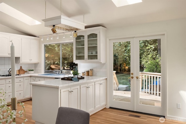 12802 NE 26th Pl, Bellevue, WA 98005 - kitchen with a skylight, tile counters, plenty of natural light, and vaulted ceiling