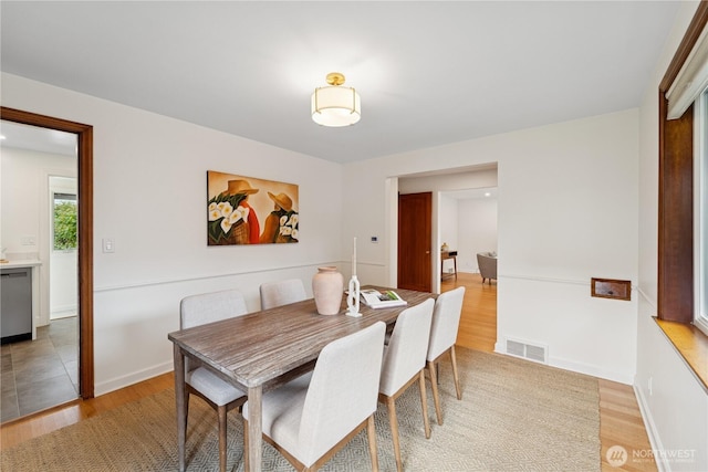 dining room featuring light wood-style floors and baseboards