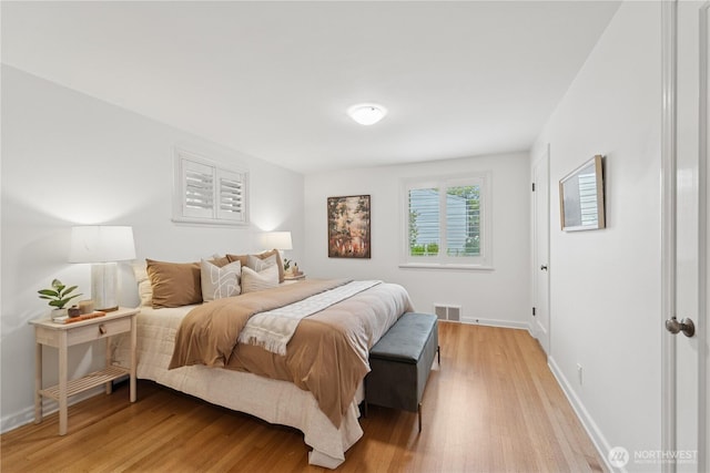 bedroom featuring light wood-type flooring and baseboards