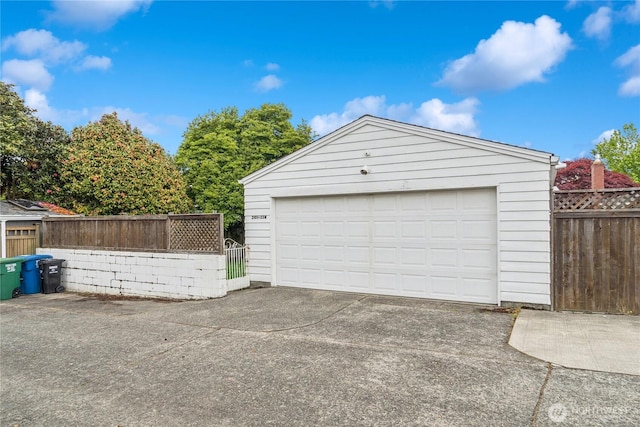 detached garage featuring fence