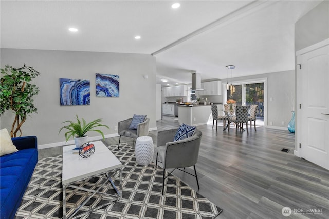 living room featuring baseboards, recessed lighting, vaulted ceiling with beams, and wood finished floors