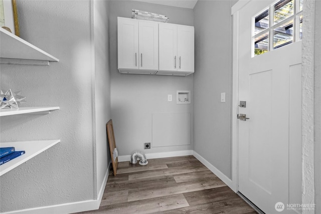 laundry room with baseboards, hookup for a washing machine, wood finished floors, cabinet space, and electric dryer hookup