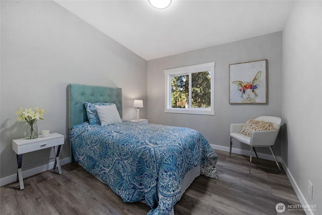 bedroom featuring wood finished floors and baseboards