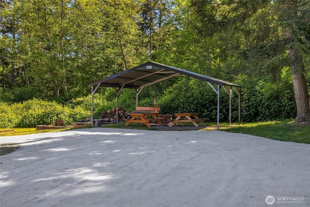view of property's community featuring a wooded view and a carport