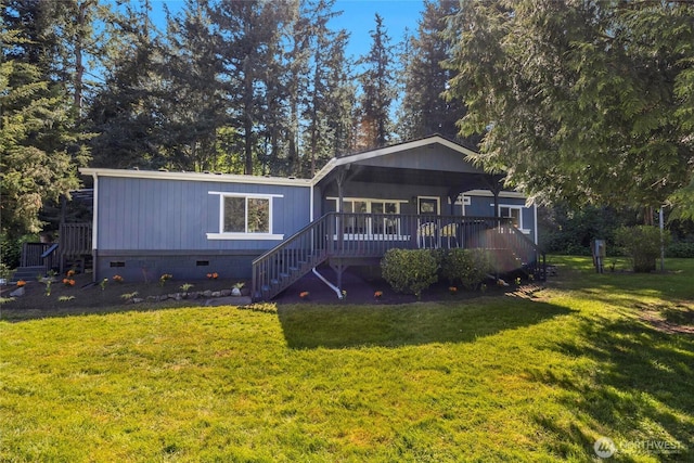 view of front of home with stairs, a wooden deck, a front yard, and crawl space