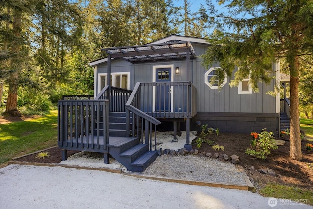 view of front of home with stairs and a wooden deck