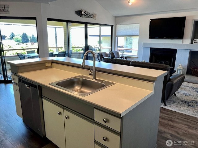 kitchen with dishwasher, dark wood-style flooring, open floor plan, and a sink
