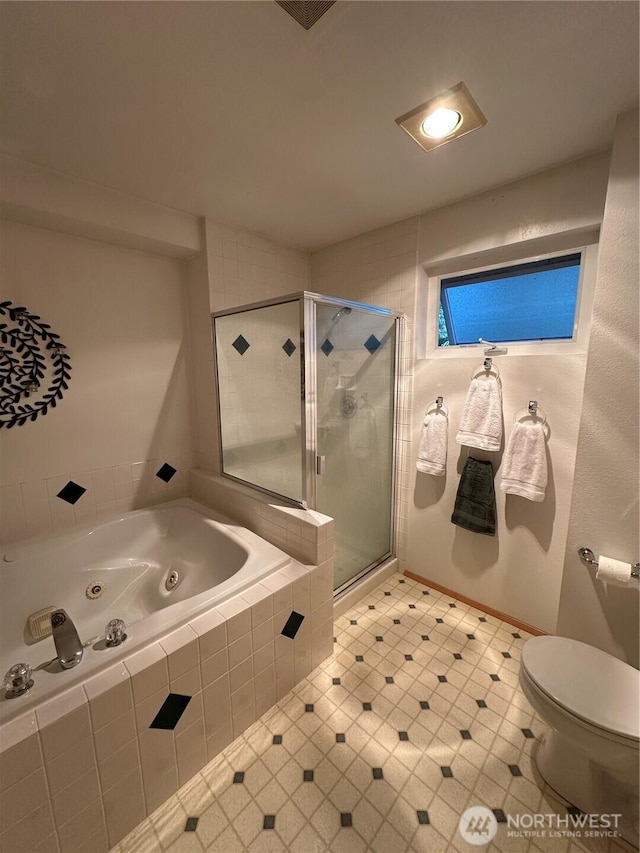full bathroom with a tub with jets, a shower stall, toilet, and tile patterned flooring