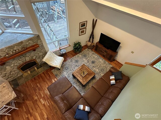 living room with wood finished floors and a fireplace