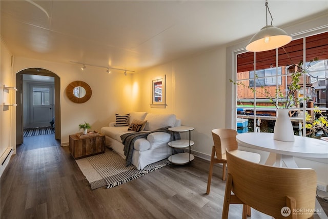 2035 Fairview Ave E Unit D, Seattle, WA 98102 - living room featuring baseboards, arched walkways, wood finished floors, and track lighting