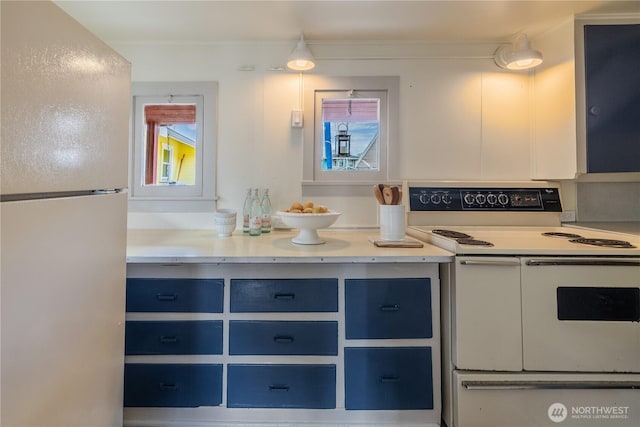 2035 Fairview Ave E Unit D, Seattle, WA 98102 - kitchen with blue cabinets, white appliances, and light countertops