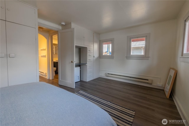 2035 Fairview Ave E Unit D, Seattle, WA 98102 - bedroom with a baseboard radiator, dark wood-style flooring, arched walkways, and a baseboard heating unit
