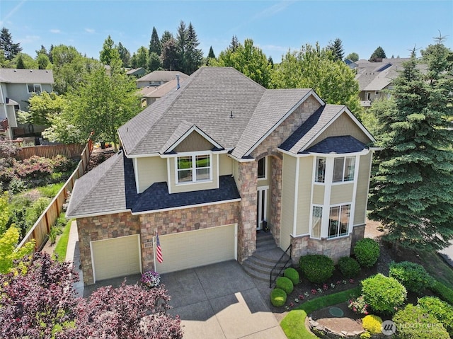1610 NW 34th Ave, Camas, WA 98607 - craftsman-style home with stone siding, roof with shingles, concrete driveway, and a garage