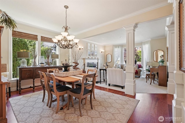 1610 NW 34th Ave, Camas, WA 98607 - dining area featuring decorative columns, ornamental molding, dark wood-type flooring, and a chandelier