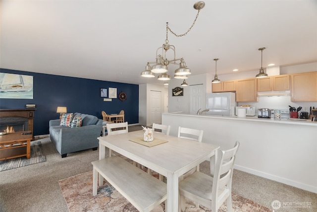 dining room with baseboards, recessed lighting, and light colored carpet