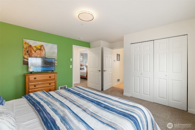 carpeted bedroom with a closet and visible vents