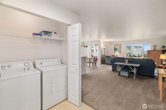 laundry area featuring laundry area, light colored carpet, a healthy amount of sunlight, and washing machine and clothes dryer