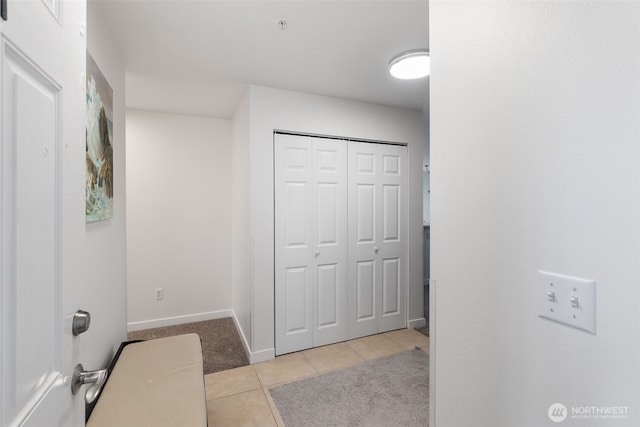 tiled foyer entrance with baseboards