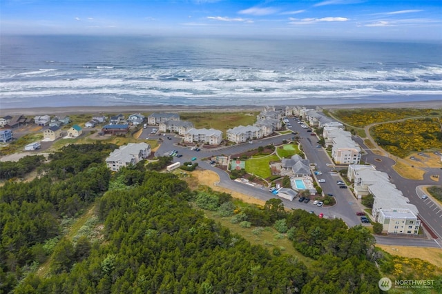 aerial view with a residential view, a view of the beach, and a water view