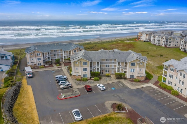 birds eye view of property featuring a water view and a view of the beach