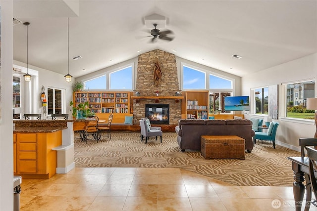 living room featuring a ceiling fan, light tile patterned flooring, and a wealth of natural light
