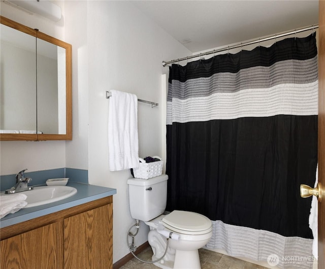 325 NE Kettle St Unit 102, Oak Harbor, WA 98277 - bathroom featuring toilet, a shower with shower curtain, and vanity