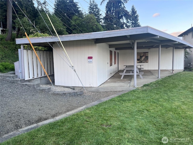 back of property featuring a yard and a patio