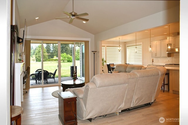 living room featuring a ceiling fan, light wood-style floors, high vaulted ceiling, and recessed lighting