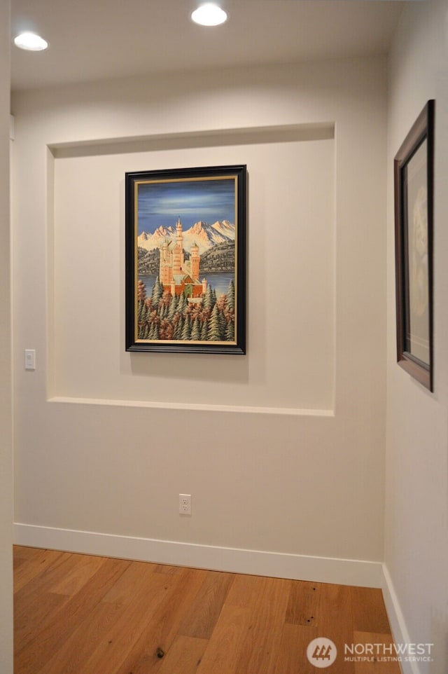 detailed view of wood finished floors, recessed lighting, and baseboards