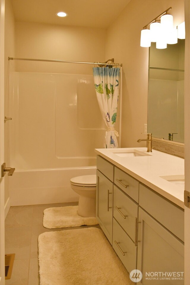 full bath featuring recessed lighting, shower / bath combination with curtain, toilet, double vanity, and tile patterned floors