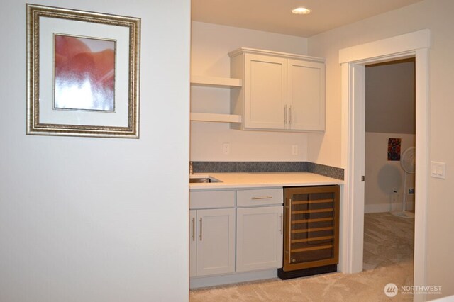 indoor bar with wine cooler and light carpet