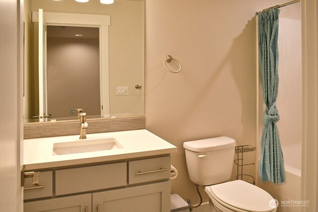 full bathroom with toilet and vanity