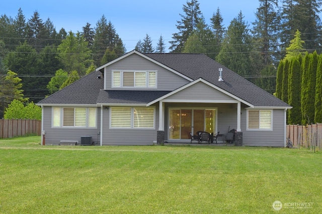 rear view of house with central AC unit, roof with shingles, and a patio area