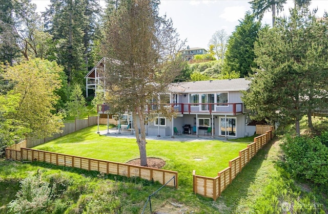 4966 Bradley Ln, Freeland, WA 98249 - back of house featuring a yard, a patio, a wooden deck, and a fenced backyard