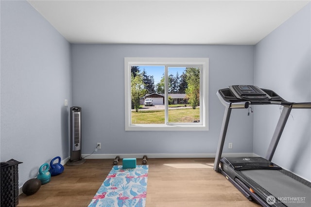 workout area with wood finished floors and baseboards