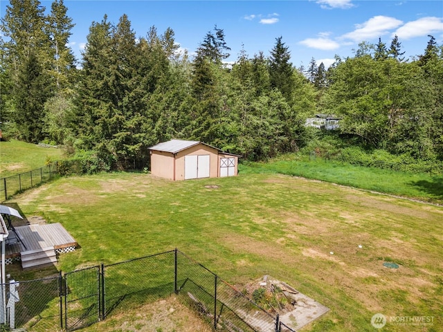 view of yard featuring a storage shed and an outbuilding