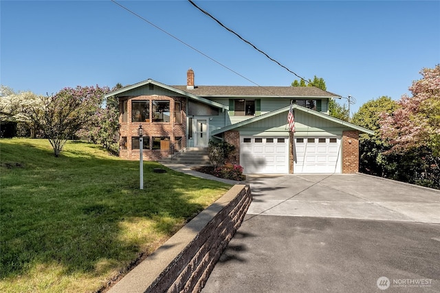 split foyer home with a front lawn, brick siding, a garage, a chimney, and concrete driveway
