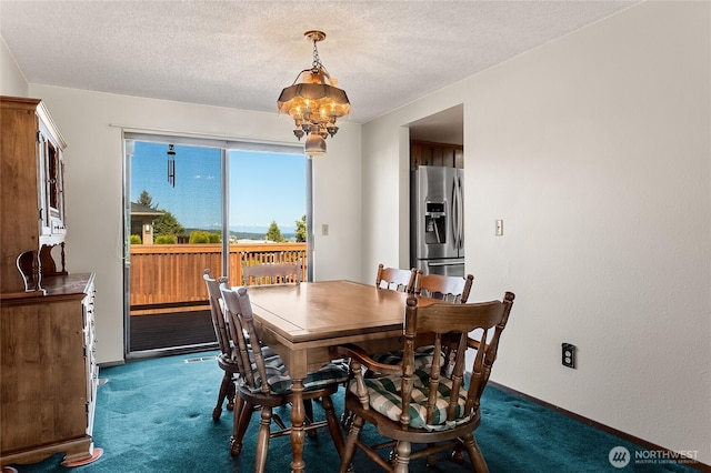 dining room with baseboards, a textured ceiling, carpet, and a chandelier