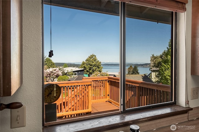 entryway featuring a textured wall and a water view