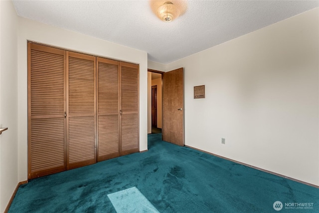 unfurnished bedroom with a closet, carpet flooring, and a textured ceiling