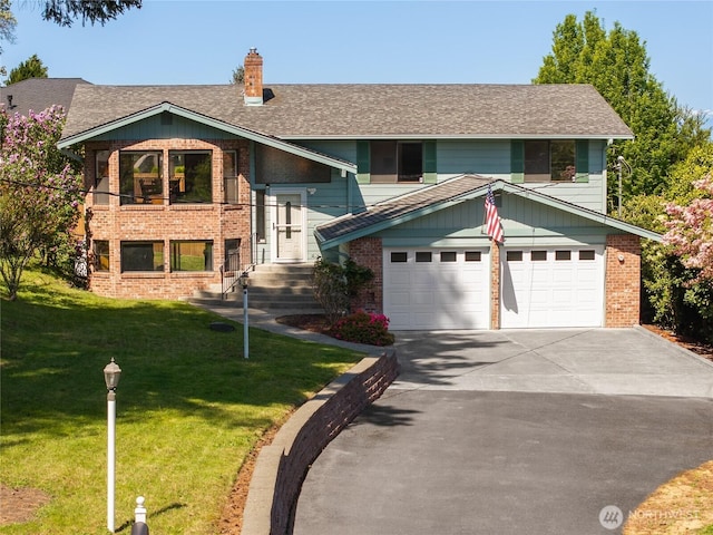 split foyer home with a shingled roof, a front lawn, brick siding, a chimney, and concrete driveway