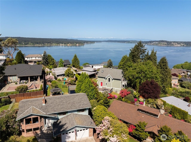 birds eye view of property with a water view and a residential view
