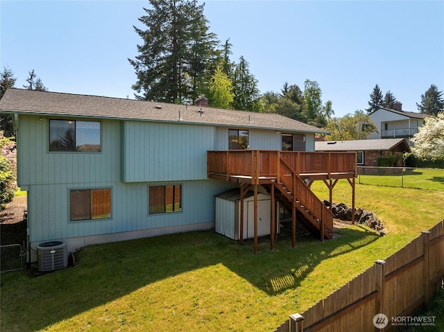 rear view of property featuring a deck, a fenced backyard, central AC unit, a storage shed, and stairway