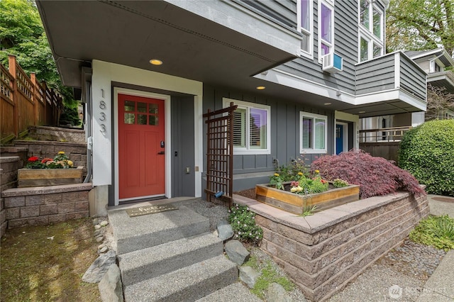 view of exterior entry featuring board and batten siding