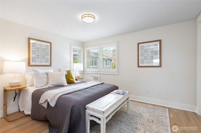 bedroom with light wood-type flooring and baseboards