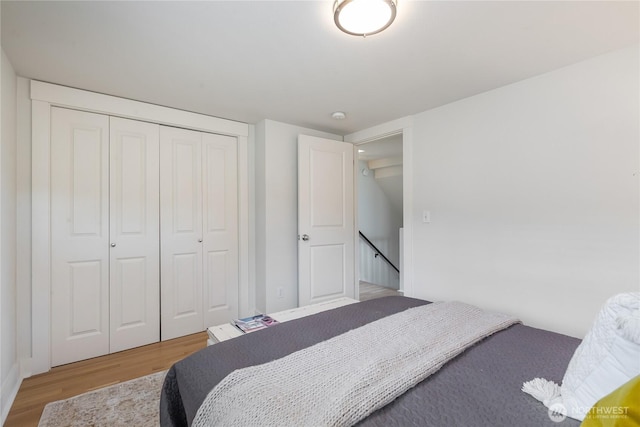 bedroom featuring wood finished floors and a closet
