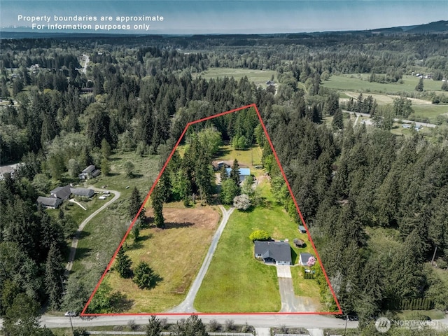 view of property location featuring a forest and property boundaries highlighted